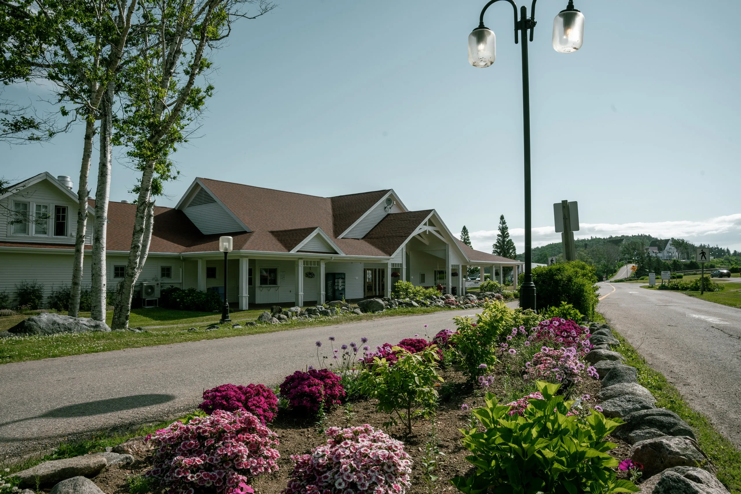 White cottages and flower beds along the road at the resort.