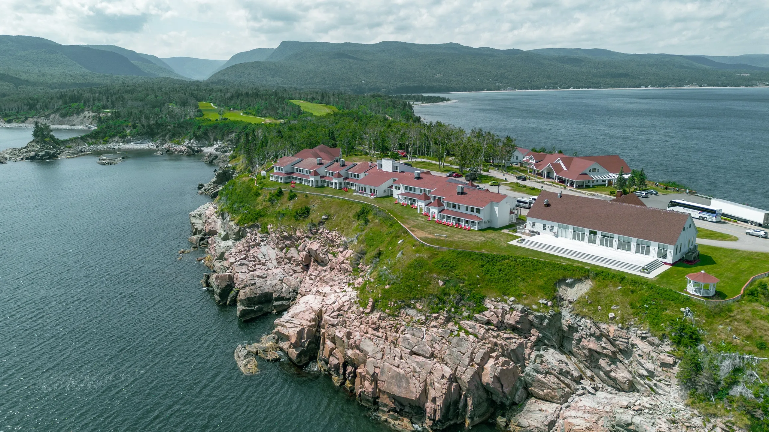 An aerial view of the resort’s white buildings with red roofs on a rocky point above the Atlantic.