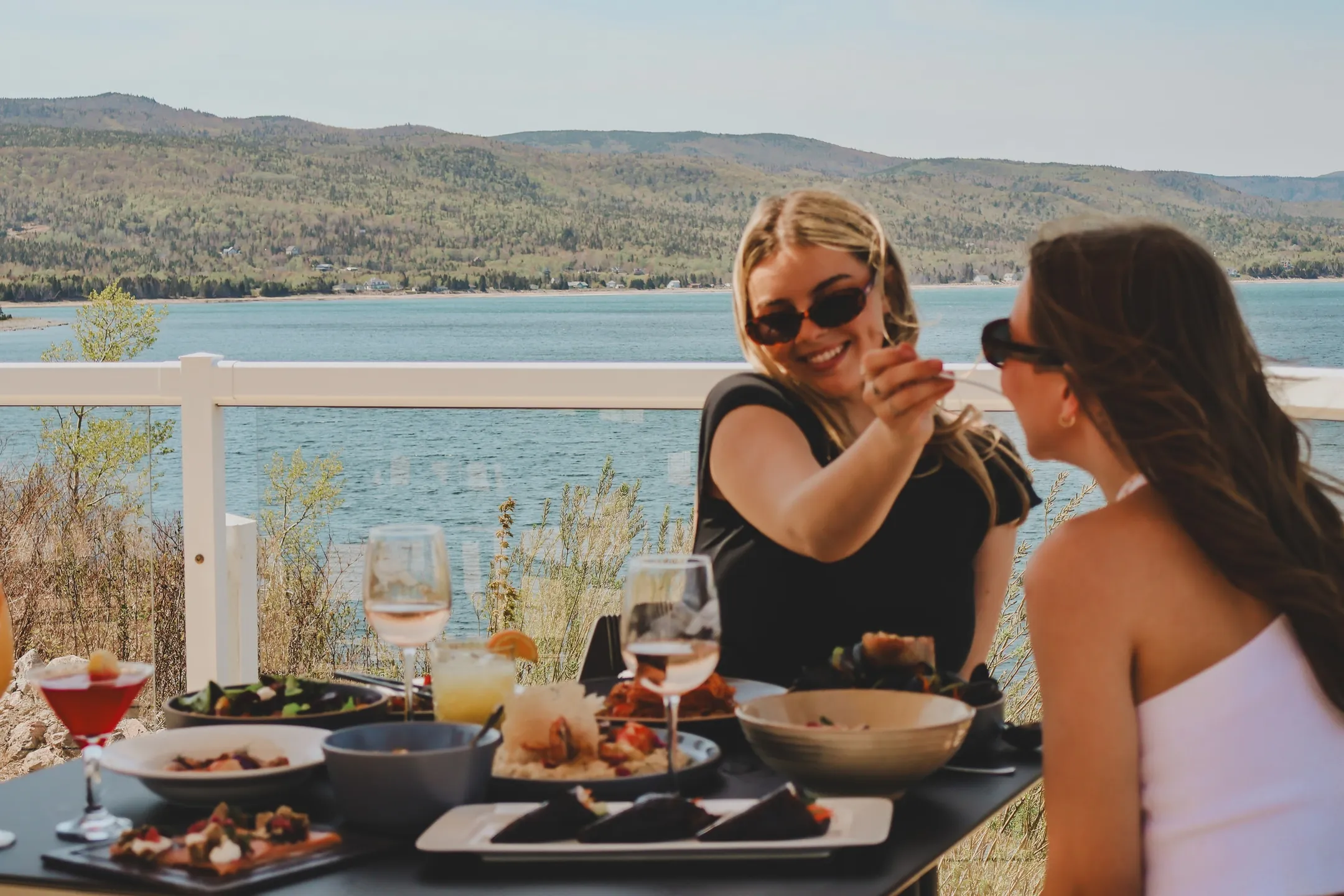 Two people dining on an oceanfront patio