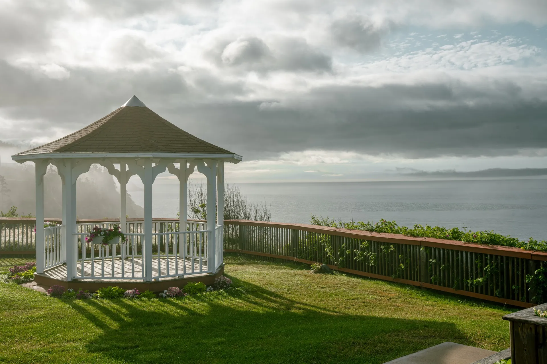 White gazebo on the lawn above the ocean at The Keltic Resort